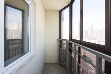 the balcony of an apartment on the upper floors of an apartment buildingの写真素材