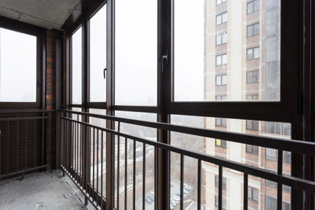 the balcony of an apartment on the upper floors of an apartment buildingの写真素材