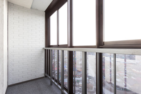 the balcony of an apartment on the upper floors of an apartment buildingの写真素材