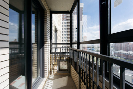 the balcony of an apartment on the upper floors of an apartment buildingの写真素材