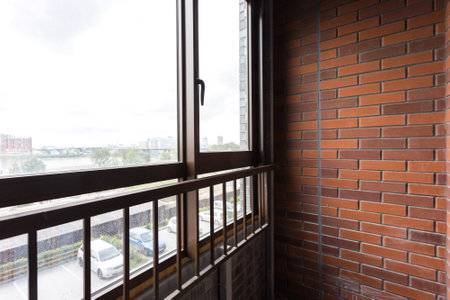 the balcony of an apartment on the upper floors of an apartment buildingの写真素材
