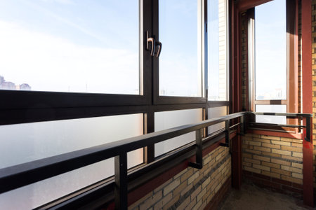 the balcony of an apartment on the upper floors of an apartment buildingの写真素材
