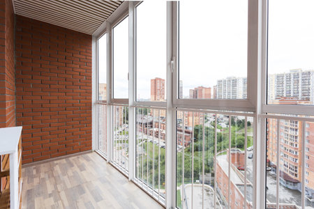 the balcony of an apartment on the upper floors of an apartment buildingの写真素材