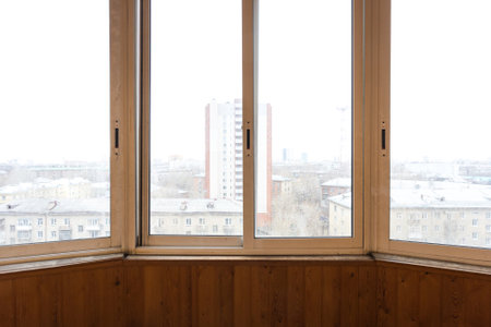 the balcony of an apartment on the upper floors of an apartment buildingの写真素材