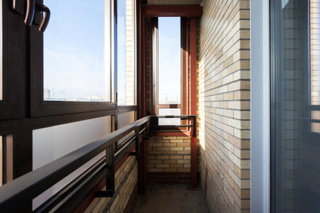 the balcony of an apartment on the upper floors of an apartment buildingの写真素材