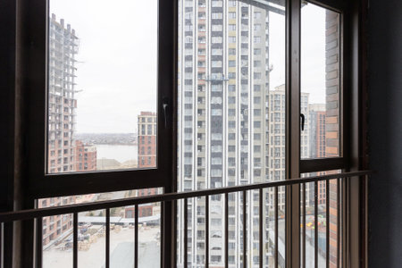 the balcony of an apartment on the upper floors of an apartment buildingの写真素材