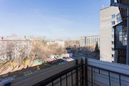 the balcony of an apartment on the upper floors of an apartment buildingの写真素材