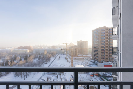 the balcony of an apartment on the upper floors of an apartment buildingの写真素材