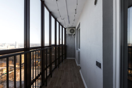 the balcony of an apartment on the upper floors of an apartment buildingの写真素材