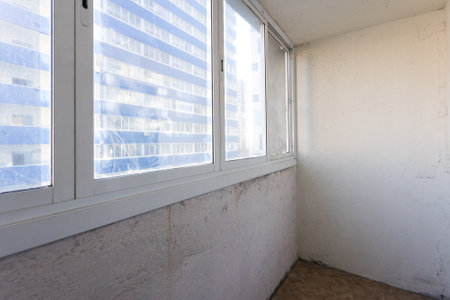 the balcony of an apartment on the upper floors of an apartment buildingの写真素材