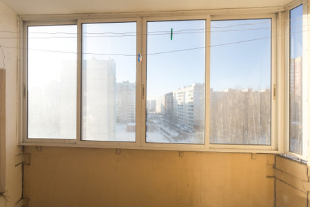 the balcony of an apartment on the upper floors of an apartment buildingの写真素材