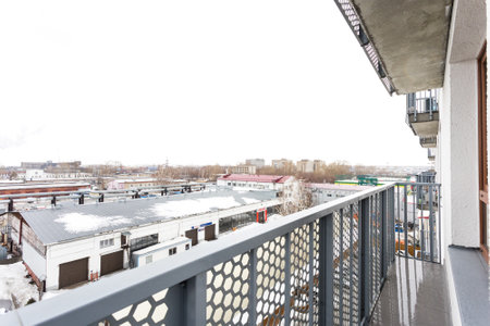 the balcony of an apartment on the upper floors of an apartment buildingの写真素材