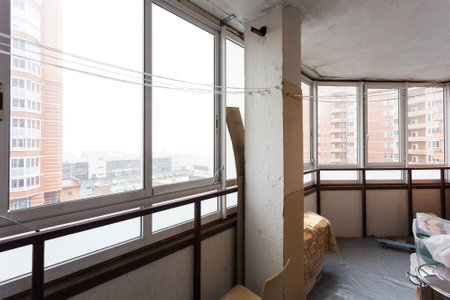 the balcony of an apartment on the upper floors of an apartment buildingの写真素材