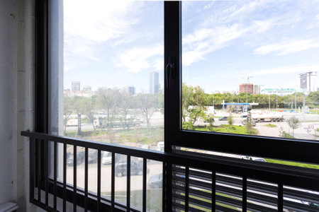 the balcony of an apartment on the upper floors of an apartment buildingの写真素材