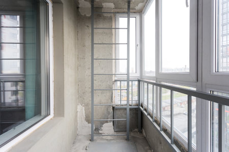 the balcony of an apartment on the upper floors of an apartment buildingの写真素材