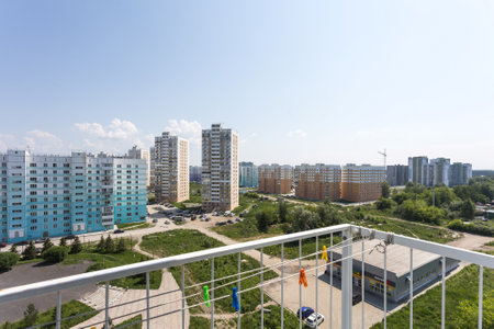 the balcony of an apartment on the upper floors of an apartment buildingの写真素材