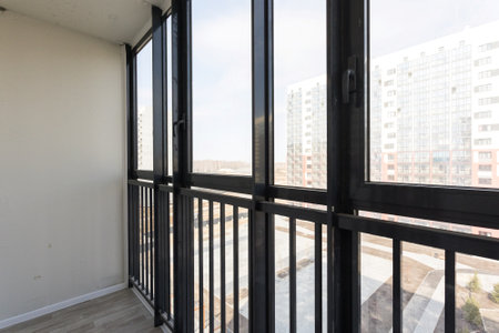 the balcony of an apartment on the upper floors of an apartment buildingの写真素材