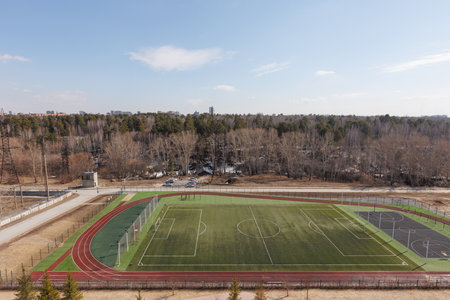 Football field in the center of the city in the early spring.の写真素材
