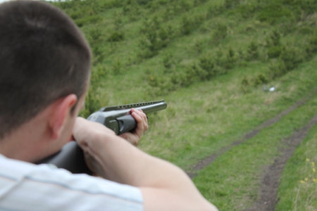 Man aiming a gun. Focus on the gun.の写真素材