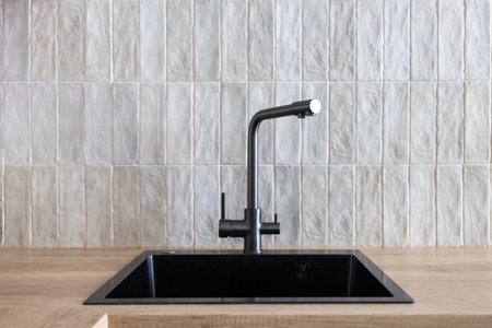 kitchen faucet on a stylish metal sinkの写真素材