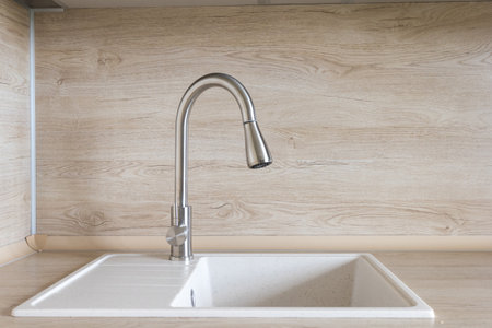 kitchen faucet on a stylish metal sinkの写真素材