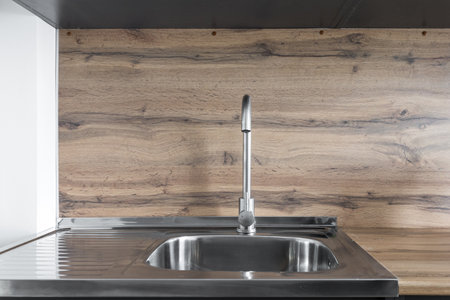 kitchen faucet on a stylish metal sinkの写真素材