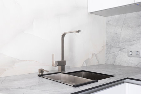 kitchen faucet on a stylish metal sinkの写真素材
