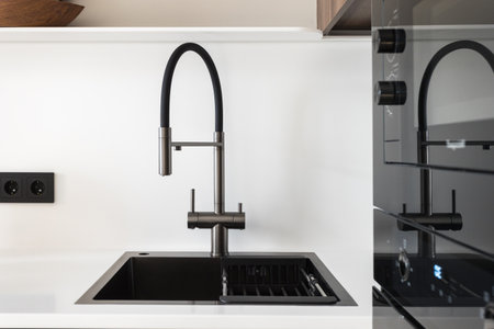 kitchen faucet on a stylish metal sinkの写真素材