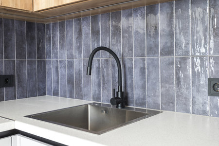 kitchen faucet on a stylish metal sinkの写真素材