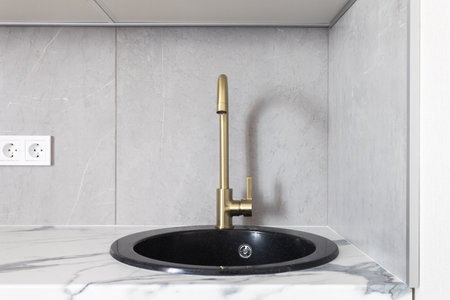 kitchen faucet on a stylish metal sinkの写真素材