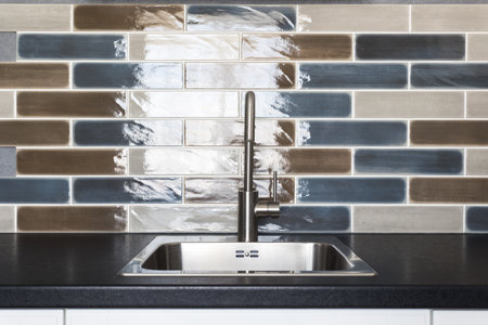 kitchen faucet on a stylish metal sink