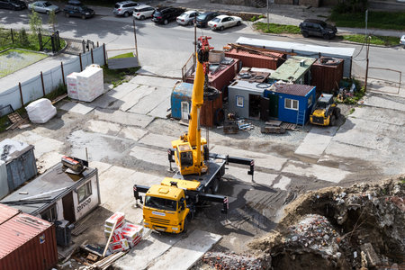Aerial view of a construction site with cranes and building materials