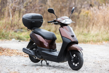 scooter of classic design with rounded shapes with a trunk for transporting things