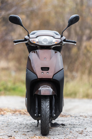 scooter of classic design with rounded shapes with a trunk for transporting things