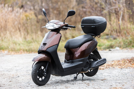 scooter of classic design with rounded shapes with a trunk for transporting thingsの写真素材
