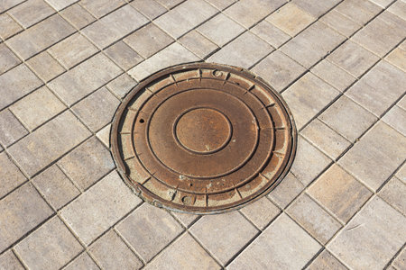 manhole cover on the tiled pavement