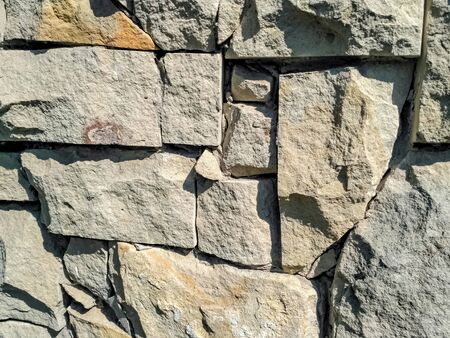 Stone floor, Stone Wall From A Large Granite Cobblestone Close-Up. Growing green moss between the seamsの写真素材