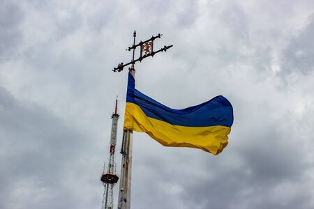 Ukraine flag waving on a background of gray sky with cloudsの写真素材
