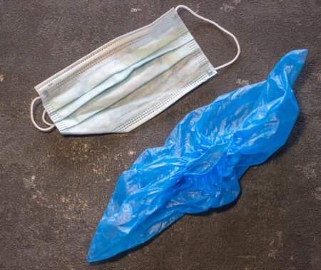 Medical mask and shoe covers on a black background. Virus and Flu Controlの写真素材
