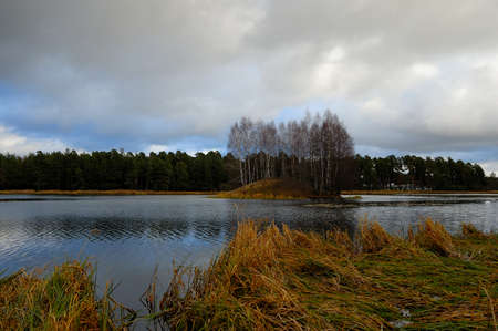 the lake with the island in autumn cloudy weather