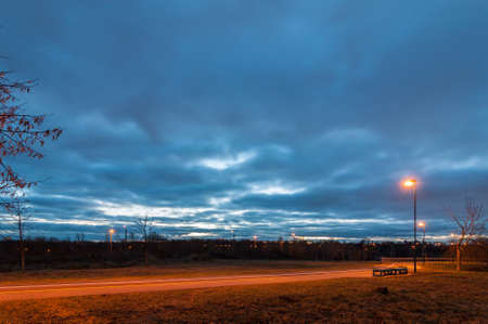 deserted city bicycle path in the cloudy autumn eveningの写真素材