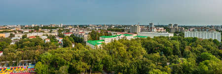 beautiful cityscape. A picturesque panoramic view of the city with a public city park in the foreground under a clear blue skyの写真素材