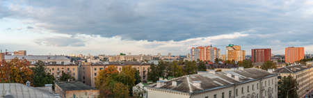 beautiful panoramic city view with old and modern buildings, roofs of houses under autumn cloudy skyの写真素材