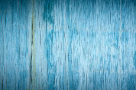 artistic background of old wooden faded cracked plywood painted blue paintの写真素材
