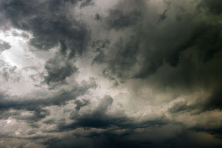 stormy gray leaden sky with heavy cumulus clouds. creative background for harsh dramatic concept design or decorationの写真素材