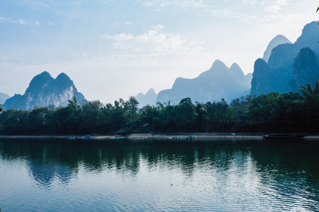 Mountains and river scenery in the mistの写真素材