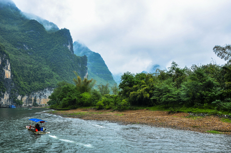 Mountains and river scenery in the mistの写真素材