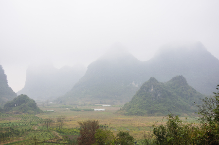 Karst mountains and  rural scenery in the mistの写真素材