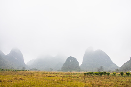Karst mountains and  rural scenery in the mistの写真素材