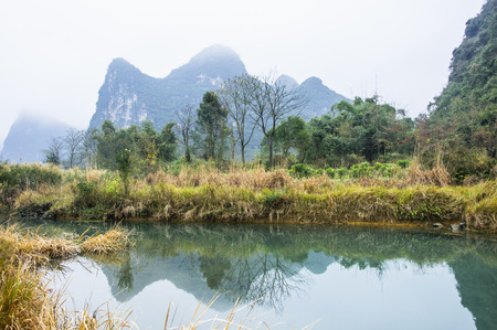 Mountains and countryside scenery in the mistの写真素材
